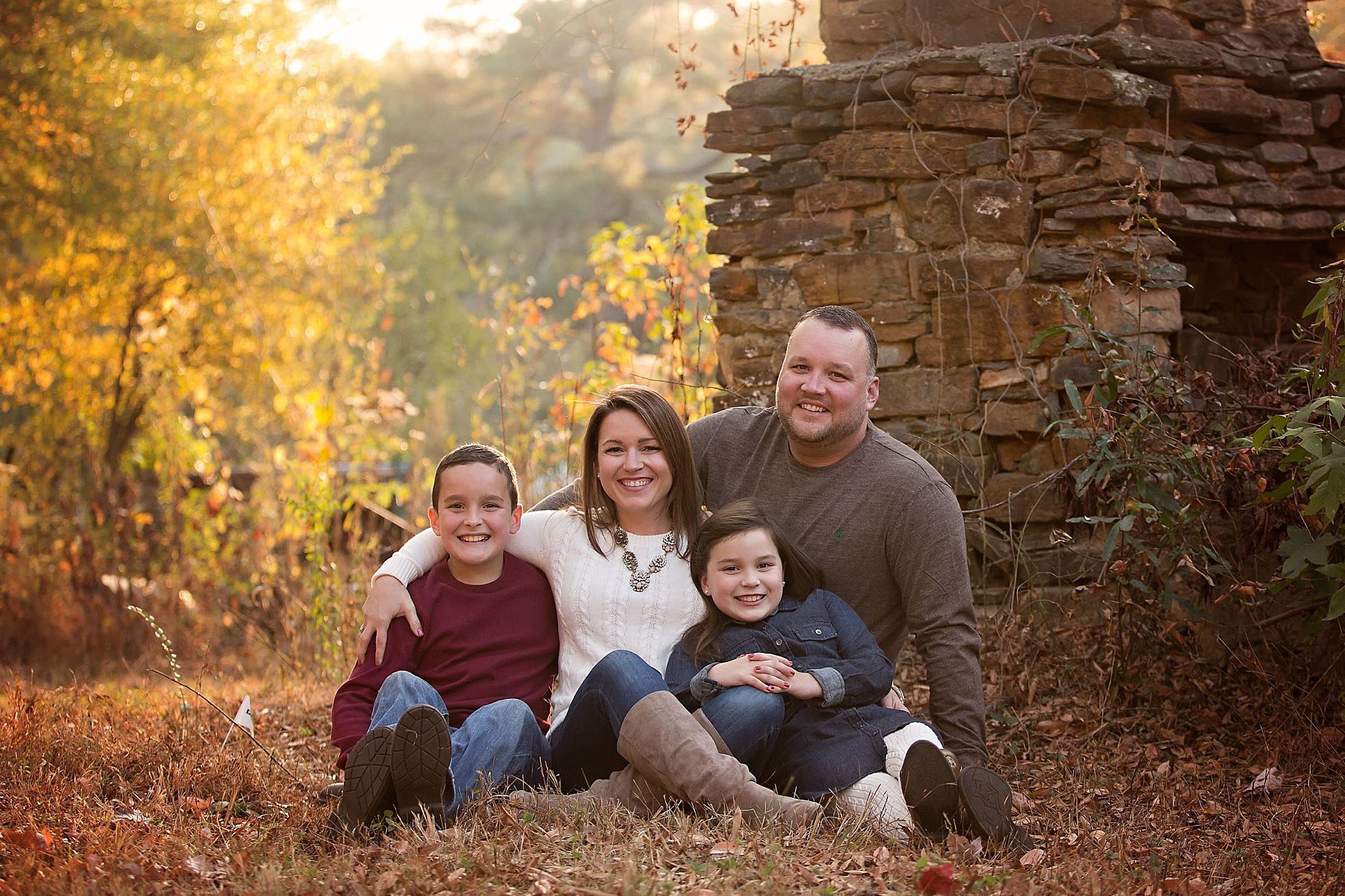 cute family by a stone fireplace near atlanta by appleseedphotography